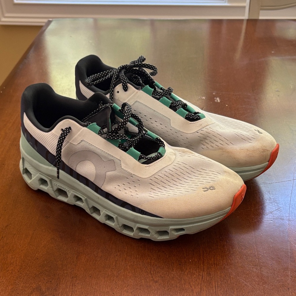 On Running Cloudstratus Shoes in White and Black with Green Highlights